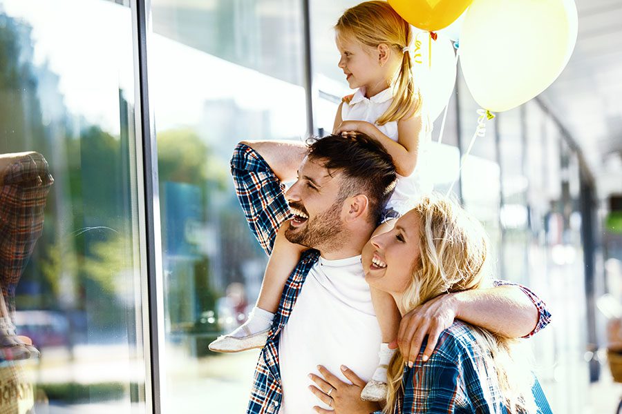 Personal Insurance - Happy Family with Young Girl Window Shopping in the City
